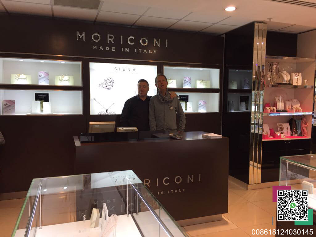 Two people at the reception desk of the MORICONI jewelry store